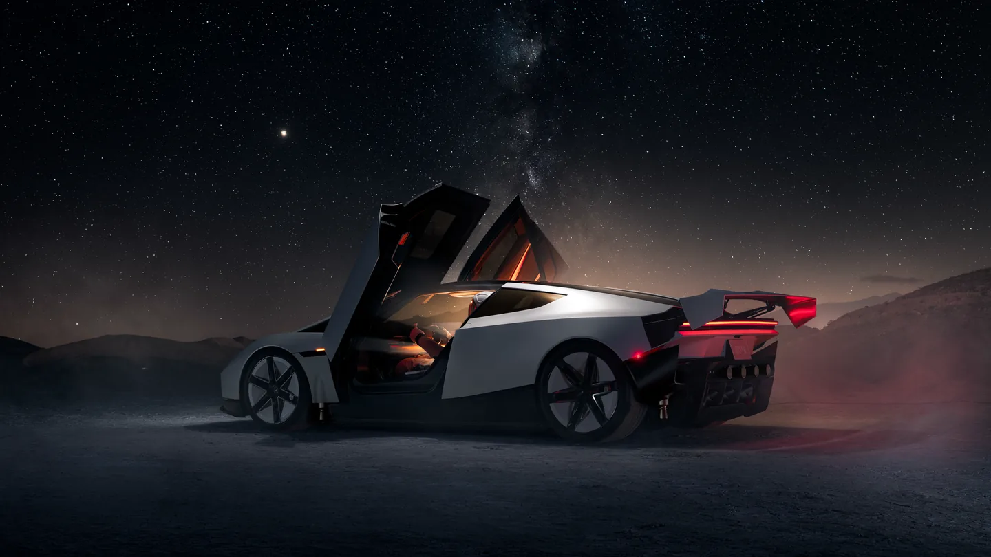 Tesla Roadster seen from the rear three-quarter with doors raised under a starry night sky, shown by Tesla. MoovX