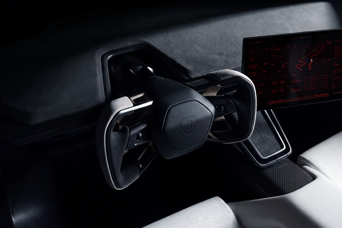 Tesla Roadster interior with a steering wheel, wide digital dashboard, and white seats in a dark cabin